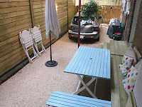 Making the best of what you have to work with. An unused space is transformed into a driveway and patio area.